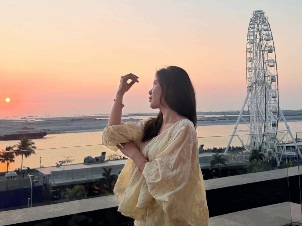 Vietnamese college student posing with a view of Manila in the background